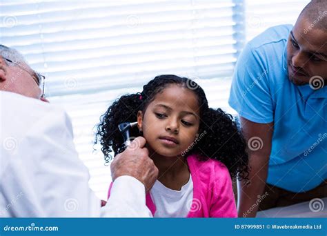 Doctor Examining Patients Ear with Otoscope Stock Image - Image of child, consulting: 87999851