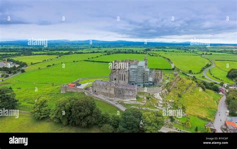 The aerial view of the Rock of Cashel and the green fields on the back of the old ruined castle ...