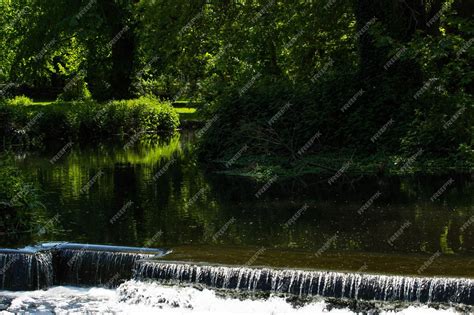 Premium Photo | A river with a waterfall in the background