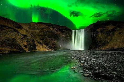 Skógafoss waterfall at night under northern lights, Iceland. | Northern ...