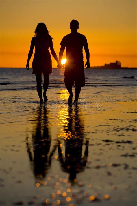 Silhouette of Love. Two lovers holding hands on the beach , #Affiliate ...