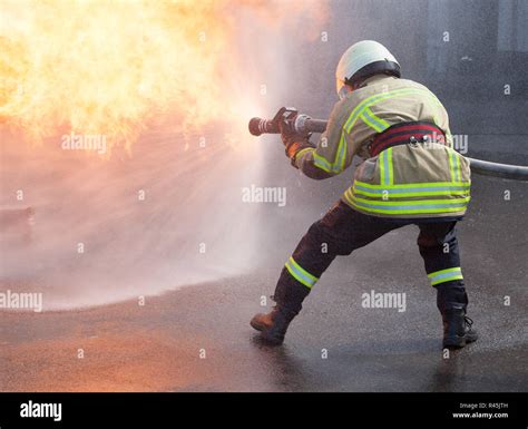 Firefighter in action Stock Photo - Alamy