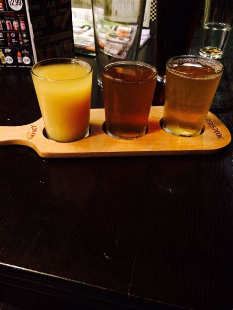 three drinks are sitting on a wooden tray