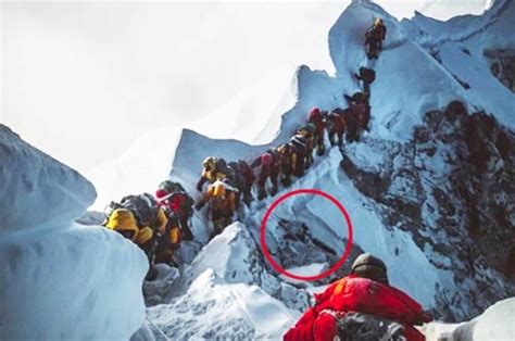 Mount Everest climbers trek past FROZEN CORPSE on peak that has claimed 11 lives in 9 days ...