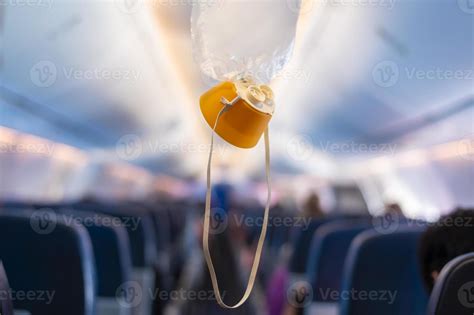 oxygen mask drop from the ceiling compartment on airplane 22333073 Stock Photo at Vecteezy