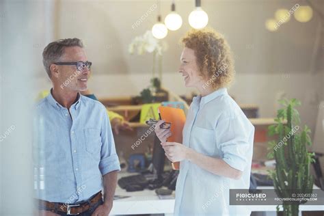 Three office workers talking at office — planning, standing - Stock ...