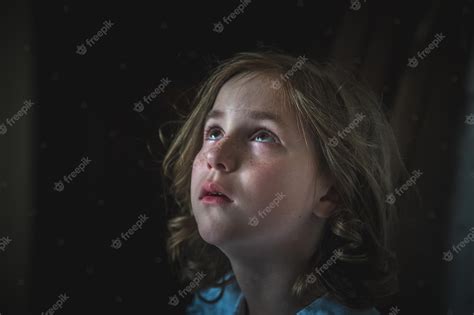 Premium Photo | A little girl sits alone in a dark hallway fear loneliness