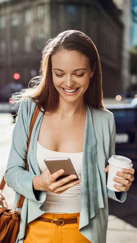 smiling-female-holding-mobile-phone - FoneFix