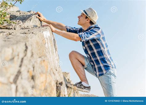 Male Hiker Climbing Up Mountain Cliff during Hiis Travel Stock Photo ...