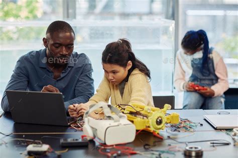 Male Teacher in Robotics Class with Young Student Stock Photo by ...