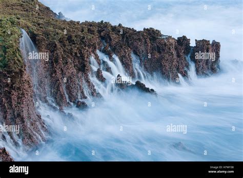 Water cascading down cliffs into ocean, Christmas Island National Park ...