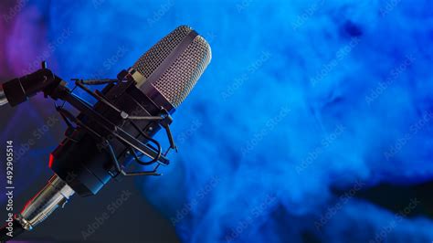 Studio microphone on blue smoke background. Vocal, blogger and sound ...