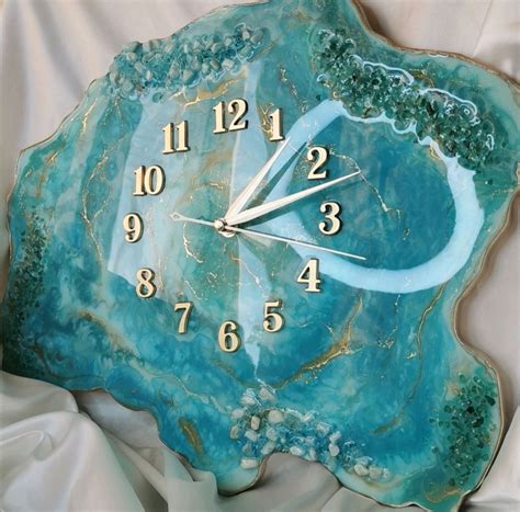 a clock made to look like a blue agate shell with gold numbers on it