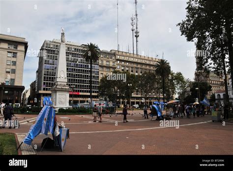 Plaza de Mayo view, souvenirs stands, Argentinian Flags, people walking ...