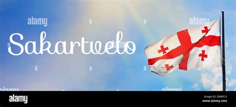 Word Sakartvelo meaning native name of Georgia near its national flag against sky, banner design ...