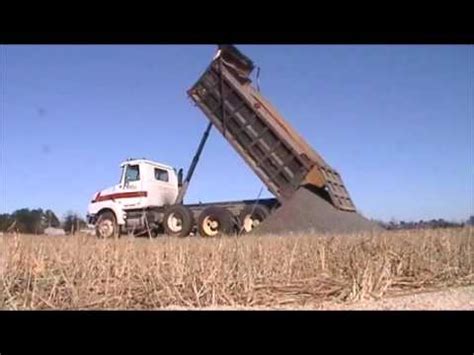 Dump truck dumping rock - YouTube