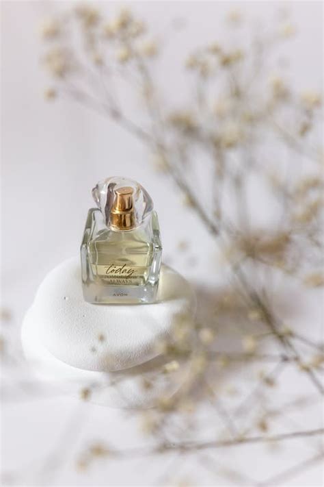 Perfume Vial and Thin Plant near · Free Stock Photo