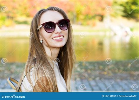 Beautiful Happy Girl in Sunglasses Smiling on a Park Background Close ...