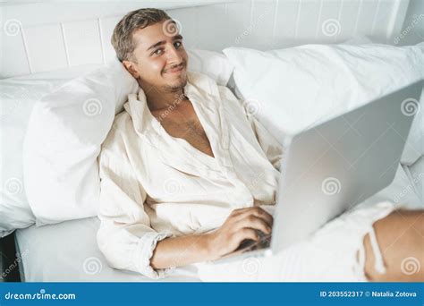 Man Laying in Bed and Working on Laptop Stock Image - Image of watch, pillow: 203552317