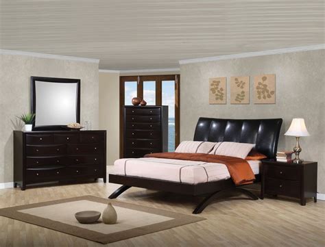 a bedroom scene with focus on the bed, dresser and nightstands in the ...