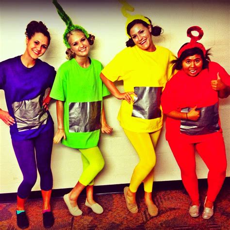 three women in colorful costumes posing for the camera with their hands ...