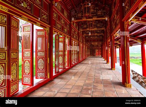 Corridor and red doors in the Forbidden Purple City of The Imperial City of Hue, Vietnam. Inside ...
