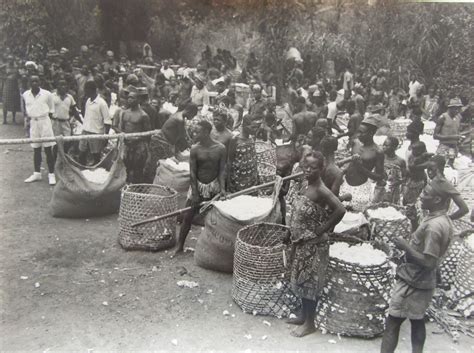 an old black and white photo of people with baskets