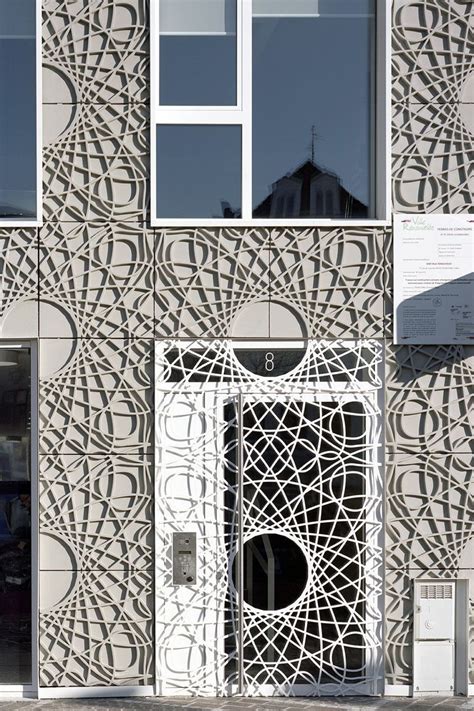 This building facade is covered in decorative panels made from concrete | Facade architecture ...