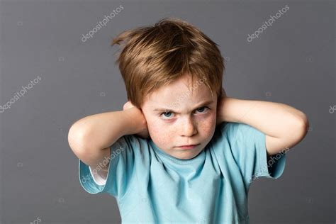 Stubborn kid with an attitude ignoring parents scolding, blocking ears Stock Photo by ...