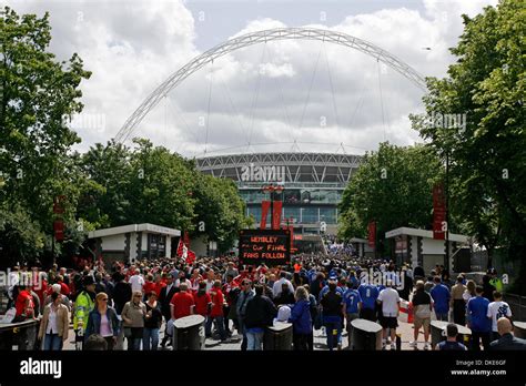 Fans walk along Wembley Way for the first FA Cup final at the new Wembley stadium.(Credit Image ...