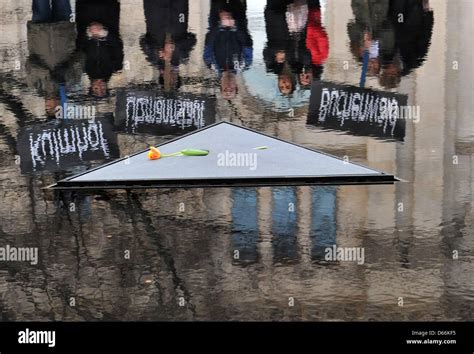 People present signs with the names of former National Socialist concentration camps at the ...