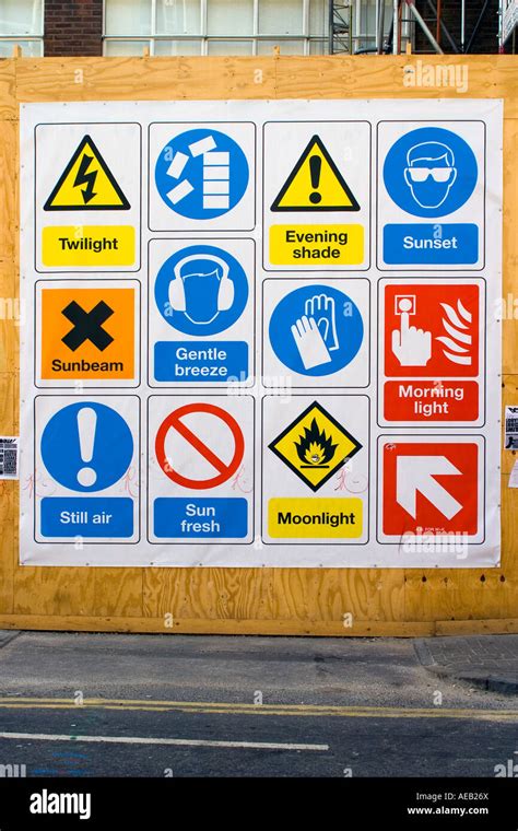 Amusing weather construction warning signs on building site board wall Stock Photo - Alamy