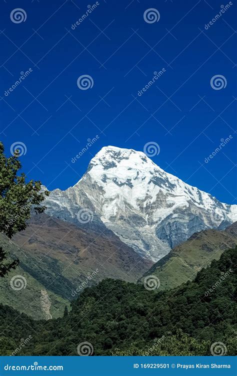 Top of the Hill, Covered with Snow and White Clouds Stock Image - Image ...