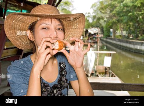 Young woman tasted fried chicken Stock Photo - Alamy