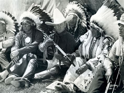 Col. Tim McCoy smoking peace pipe with Indians when he joined MGM studio as their new film star ...