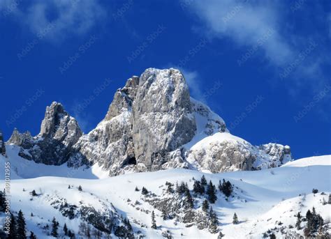 Snow-covered high alpine pastures and rocky peaks of the Alpstein massif in winter attire ...