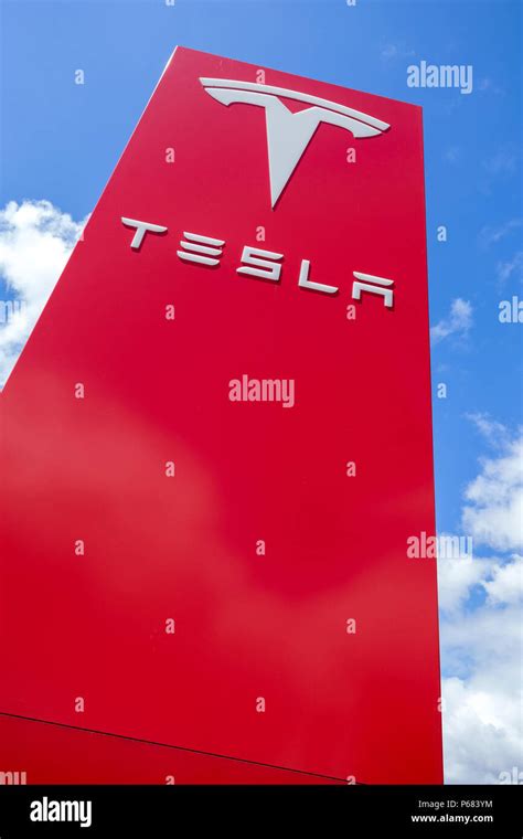 Tesla dealership sign against blue sky Stock Photo - Alamy