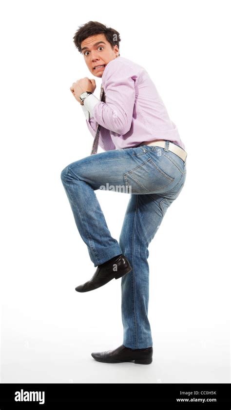 Scared man running away with grimace in his face wearing jeans, shirt and tie Stock Photo - Alamy