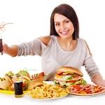 Woman eating fast food. Stock Photo by ©poznyakov 12802299