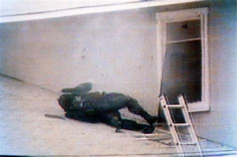 A Federal officer lays injured on the roof. Six Davidians are killed ...