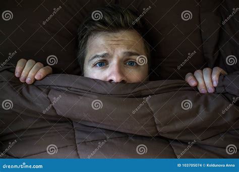 Caucasian Young Man Hiding in Bed Under the Blanket at Home. Stock Photo - Image of eyes ...