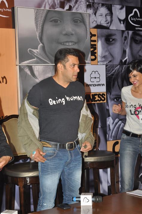 Salman Khan showcasing his BEING HUMAN T Shirt at the press meet ...