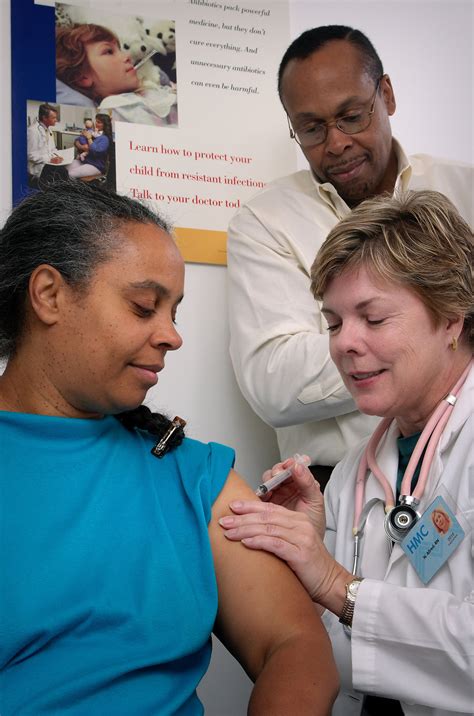 Shot | Free Stock Photo | A nurse giving a middle-aged woman a vaccination shot | # 16733