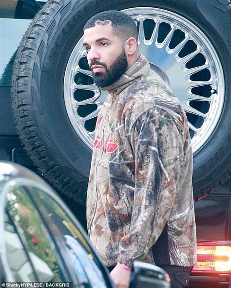Drake is all business as he shows off his signature heart design buzzcut while leaving an LA ...