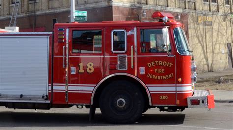 Detroit firefighters under fire for photo in front of burning home