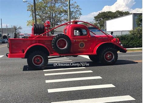 an old red fire truck is parked on the street