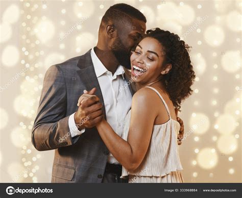 Beautiful happy black couple dancing in modern restaurant — Stock Photo © Milkos #333968884