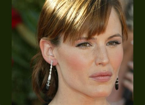 Jennifer Garner with her hair in an updo with a loose bun and bangs