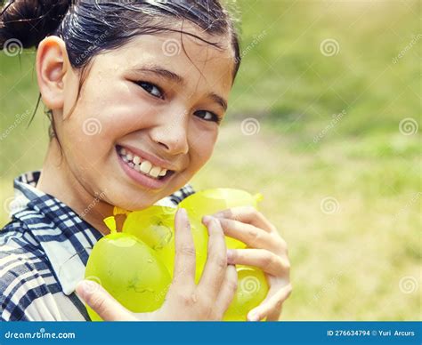 All Smiles she Got All the Water Balloons. Portrait of an Adorable Little Girl Playing with ...