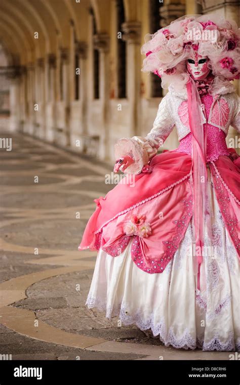 A woman posing her Carnival mask and dress at the Doge's Palace during ...